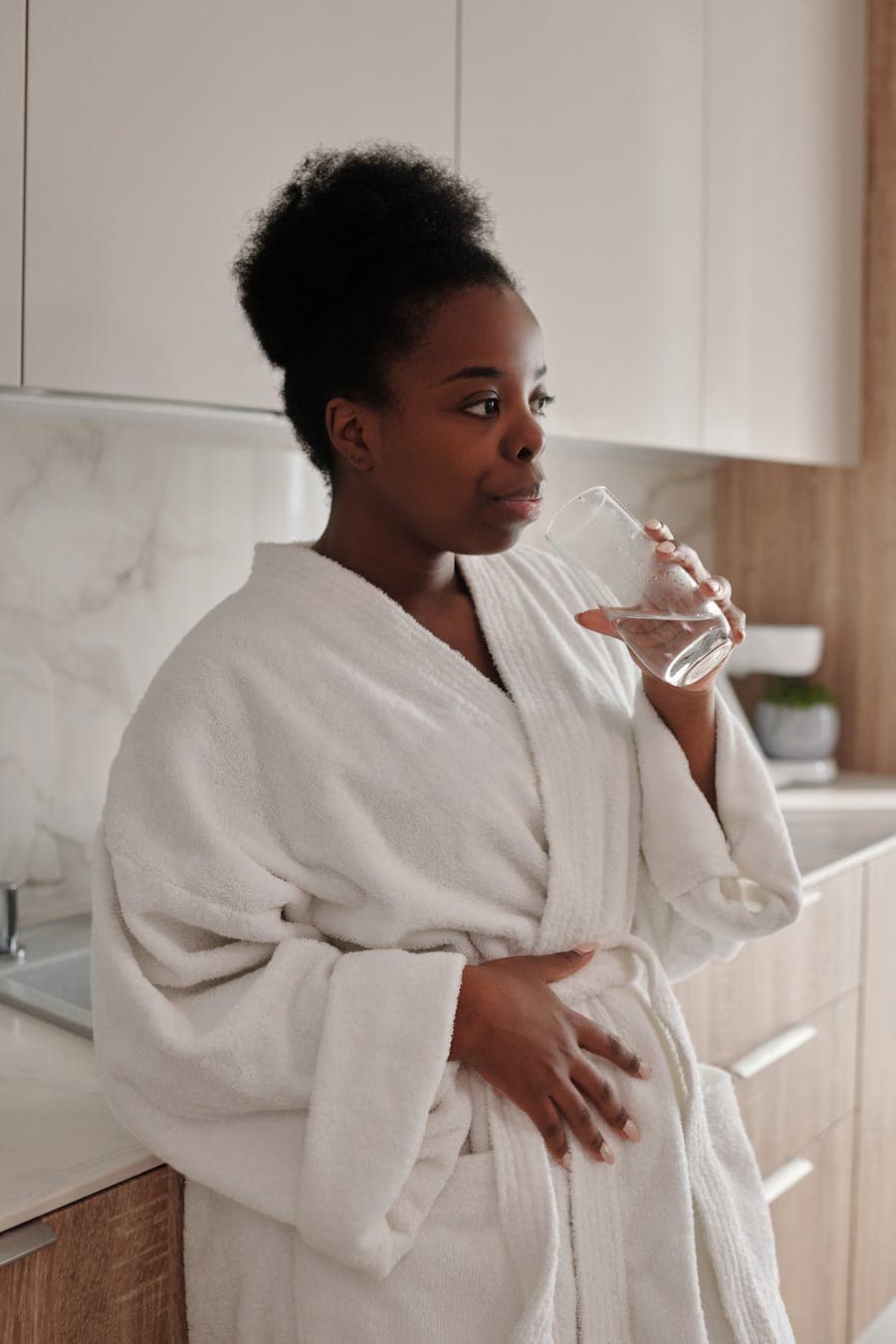 Woman enjoying clean filtered water at home